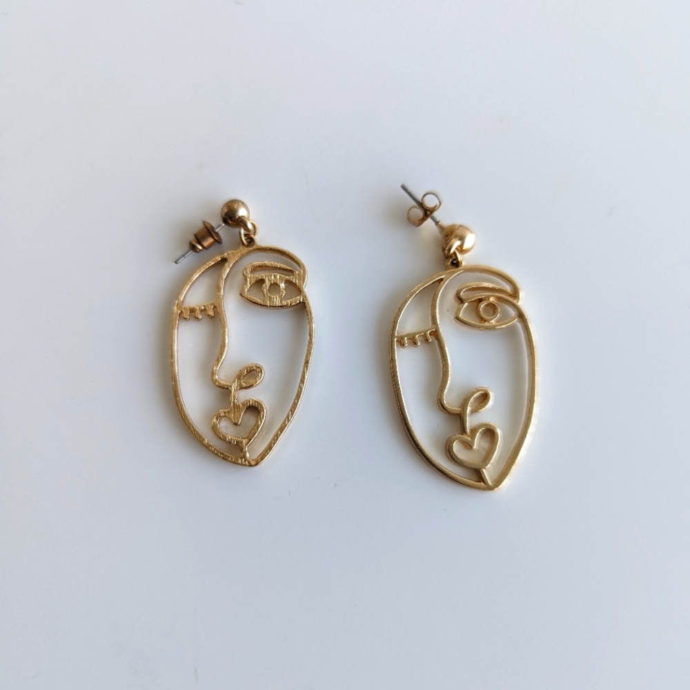 Gold Toned Picasso face dangle earrings